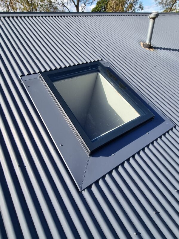 Square skylight on a pitched corrugated iron roof.