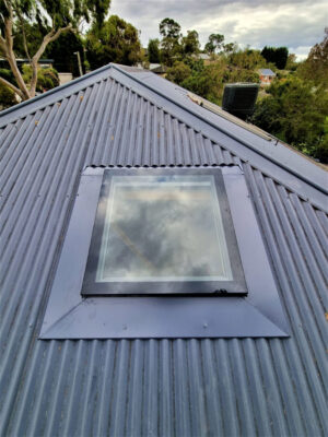Skylight installation on a corrugated iron roof.