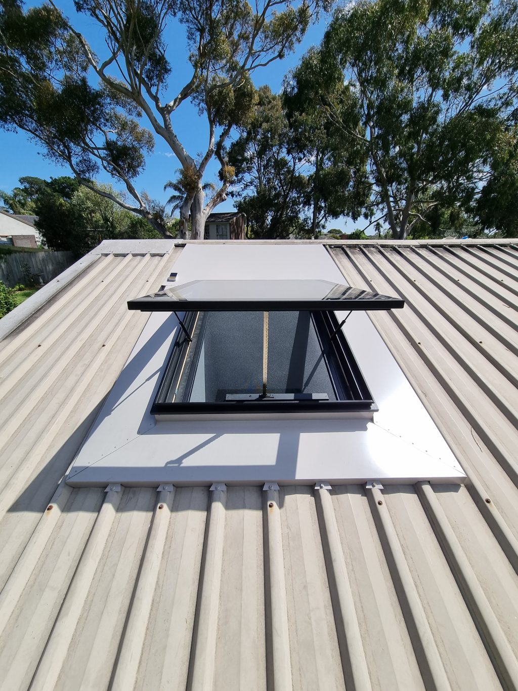Electric opening skylight on metal roof
