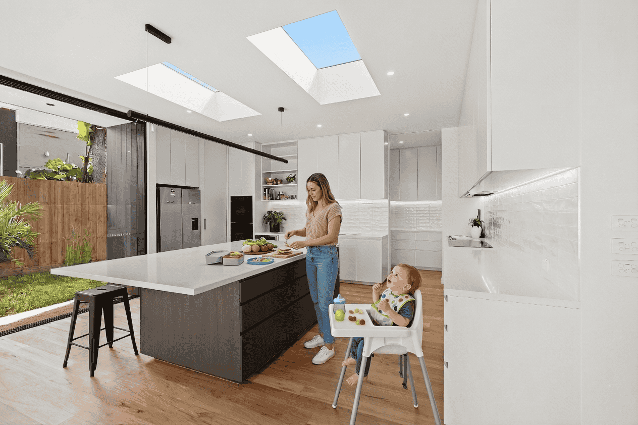 Meal preparation in kitchen under two Skylights